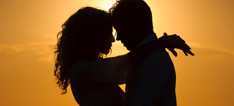Couple embracing at sunset silhouette